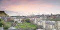 Edinburgh city panoramic view with Canongate Cemetery in pink purple sunset, Edinburgh.