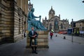 Edinburgh, Scotland - April 27, 2017: Bagpipe player with traditional scottish highlander robes playing on the Royal