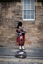 Edinburgh, Scotland - April 27, 2017: Bagpipe player with traditional scottish highlander robes playing on the Royal Mile