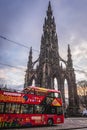 CitySightseeing double decker tourist bus and famous Scott Monument in Edinburgh Royalty Free Stock Photo