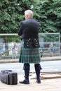 Bagpipes Player in Kilt on Pavement Royalty Free Stock Photo