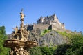 Edinburgh Scotland: Edinburgh Castle on a summer day with blue sky with Ross Fountain lit up in warm sunlight