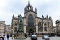 Edinburgh, Scotland, 15 June 2019: Tourists and the old building of St Giles Cathedral on the historic Royal Mile street and area