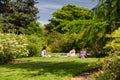 People lying on grass in park