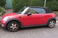 Red Mini Cooper car new model, produced from 2013 onwards with black roof