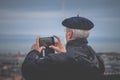 Edinburgh, UK - February 10, 2018. Tourist man taking panoramic pictures in Edinburgh, Scotland