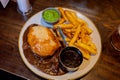 Traditional steak and ale pie and a pint in a Scottish pub with chips, gravy and mushy peas