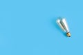 edison lamp on an isolated blue background. Flat lay with copyspace. Concept ecology, save planet earth Royalty Free Stock Photo