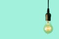 Edison light bulb on turquiose background