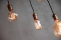Edison retro lamp incandescent bulbs on gray plaster wall background in loft. Concept Vintage style. Copy space Royalty Free Stock Photo