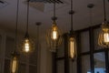 Edison`s antique lamps of various shapes and sizes glow in the dark under the ceiling
