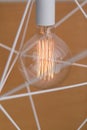 Edison`s light bulb and lamp in modern style. Warm tone light bulb lamp. Geometric design. Royalty Free Stock Photo