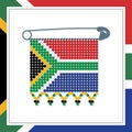 Framed South African flag with beaded ornamental emblem pin