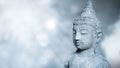 edited image of laughing Buddha face, The Buddha statue is made of stone on natural bokeh background. buddha idol with