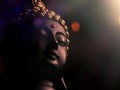 edited image of laughing buddha idol with abstract and glow lights