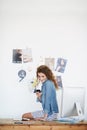 Editor on her desk, woman and smartphone with typing and magazine column with publisher and social media. Person Royalty Free Stock Photo