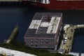 Editorial, Bibby Stockholm barge from above docked on land after arriving the day before, defocussed wall in foreground. To house