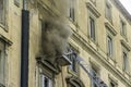 Editorial, Domestic apartment fire with smoke billowing from window. Garibaldi Square, Naples, Italy. Fire engine basket or cage
