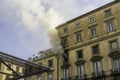 Editorial, Domestic apartment fire with smoke billowing from window. Garibaldi Square, Naples, Italy, landscape