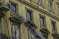 Editorial, Domestic apartment fire with smoke billowing from window. Garibaldi Square, Naples, Italy. Magirus Fire engine basket