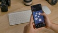 Editorial footage: A man browses photos on Shutterstock using a mobile app for his smartphone. Hands top view. Close up