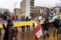 Editorial image, February 25, 2023, Novi Sad, Serbia. A crowd of people holding a large national Ukrainian flag at a