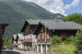Les Houches, France - July 19, 2021: Town with old wooden houses along the main road with Alps in the distance Royalty Free Stock Photo