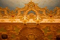 Richly decorated ceiling fragment with a clock in the auditorium of the La Fenice Theatre