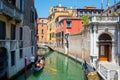 Editorial. May 2019. Venice, Italy. View of the city Canal in a sunny day. Gondolier driving the gondola with tourists Royalty Free Stock Photo