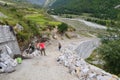 Editorial: 22nd Aug 2011: Chitkul,Sangla, Himachal, India: Unidentified workers making road and a tourist is going for a walk