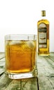 Editorial photo of Bushmills whiskey glass with logo and blurred bottle in background