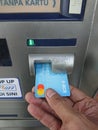 Editorial photo, indonesia, east jakarta, 10th october 2022, close up man hand make at financial transaction at ATM BCA Royalty Free Stock Photo