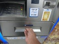 Editorial photo, indonesia, east jakarta, 10th october 2022, close up man hand make at financial transaction at ATM BCA Royalty Free Stock Photo