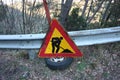 Editorial photo of a road construction site. warning signs of work in progress. cartels written in Italian. public message