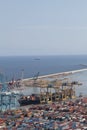 Barcelona industrial harbor with cranes containers and cargo ship being loaded