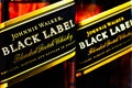 Editorial selective focus photo of Johnnie Walker Black Label Scotch whisky bottles - a brand of Scotch whisky