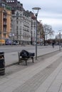 Man sleeping on a bench at the sidewalk Royalty Free Stock Photo