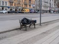 Man sleeping on a bench at the sidewalk Royalty Free Stock Photo