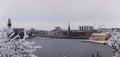 View of the Stockholm City Hall and Riddarholmen and the river on a snowy winter day, Sweden