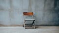 Editorial Style Photograph Of Vintage Wooden Folding Chair In Simple Brutalist Environment Royalty Free Stock Photo