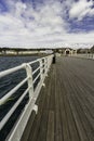 Editorial, Wide angle of pier and with hand rail in foreground , RNLI Lifeboat station and seafront houses, Beaumaris, United