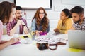 Editors discussing photos in meeting at creative office Royalty Free Stock Photo