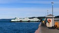 Edmonds Pier with fishermen checking catch.  Car ferry Spokane at the dock Royalty Free Stock Photo