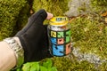 Edole, Latvia - August 28, 2015: Geocaching container - glass jar with logos in male hand Royalty Free Stock Photo