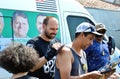 Eduardo Bolsonaro excited giving autograph using voter's back as support on the coast