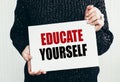 educate yourself phrase handwritten on paper in woman hands Royalty Free Stock Photo