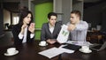 Serious managers, two men and women are burdened with work, use