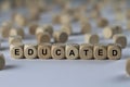 Educated - cube with letters, sign with wooden cubes