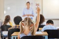 Education, back and a child raising hand in class for a question, answer or vote at school. Teaching, academic and a Royalty Free Stock Photo