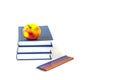 Education or back to school concept. An apple and multi-colored pencils on a stack of books Royalty Free Stock Photo